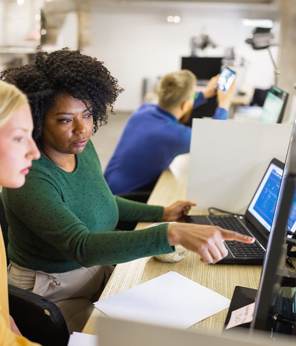 2 female colleagues sat at a workstation
